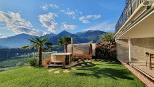 a garden with a view of the mountains at Romy & Johannes Guesthouse in Schenna