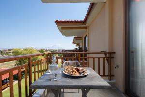 a plate of food on a table on a balcony at Rodon Garden in Sarti