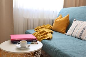 a couch and a coffee table in a room at Anastacia Premium Apartment FREE Parking & Self Check-in in Graz
