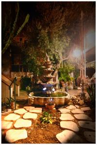 a stone walkway around a fountain in a garden at Il Villino Apartments in Bari