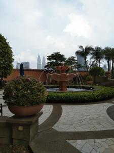 a fountain in the middle of a park at KL Short & Long Stay Suites At Times Square in Kuala Lumpur