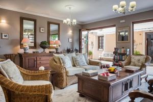 a living room with a couch and chairs and a table at Faros Residence Adults Only in Fiskardo