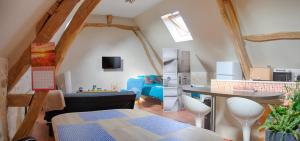 a living room with a table and a dining room at LA FERME DES NONAINS in Montjavoult