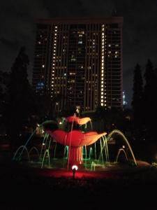 a water park in front of a city at night at KL Short & Long Stay Suites At Times Square in Kuala Lumpur