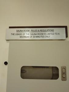 a sign on the wall above a bathroom door at KL Short & Long Stay Suites At Times Square in Kuala Lumpur