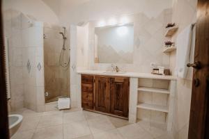 a bathroom with a sink and a shower and a mirror at Relais Villa Carola in Porto Cervo