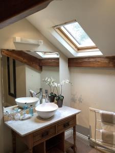 a bathroom with two sinks and a skylight at Alexandra Court in Harrogate