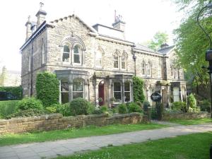 an old stone house with a stone wall at Alexandra Court in Harrogate