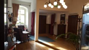 a living room with a couch and a table and chairs at eXo Hotel Franka Bamberg - by NeVo Hotels in Hallstadt