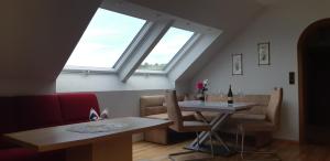 a living room with a table and a window at Wein- und Weitblick in Gleinstätten