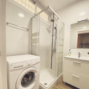 a bathroom with a washing machine and a shower at Tamarindos Apartments by ALFRESCO STAYS in Benalmadena Costa