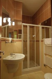 a bathroom with a glass shower and a sink at Hotel Air in Holíč