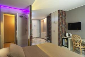 a bedroom with a bed with a purple light at Etruria Relais and Wine in Rome