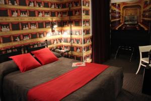 a bedroom with a large bed with a red blanket at Hôtel Victoria Châtelet in Paris