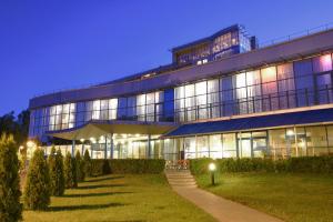 a large building with a lawn in front of it at Bellevue Park Hotel Riga with FREE Parking in Riga