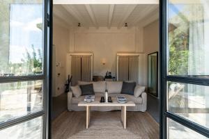 a living room with a couch and a table at Finca Serena Mallorca, Small Luxury Hotels in Montuiri