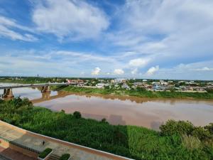 a view of a river with a bridge at Chaisaeng Palace Hotel in Sing Buri