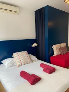 a bedroom with a bed with red towels on it at Studio Peralta in Liège