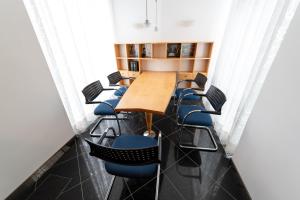 una sala conferenze con tavolo e sedie in legno di Stadthaus Seeblick G5 - Hostel a Friedrichshafen