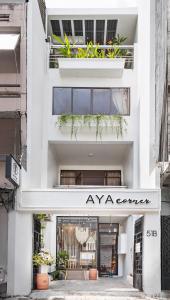 a white building with a sign that reads anytime zone at AYA Homestay 3 in Ho Chi Minh City
