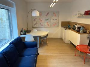 a living room with a blue couch and a table at Studio Peralta in Liège