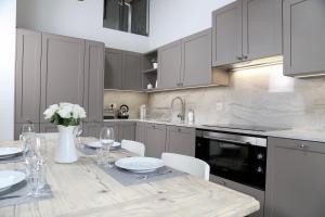 a kitchen with a table with a vase of flowers at Chalet Skyfall by Mrs Miggins in Grimentz