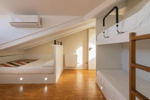 a bedroom with two beds and a staircase at Albergue The Last Stamp in Santiago de Compostela +65 photos