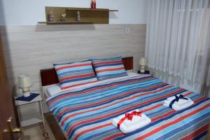 a bedroom with a bed with towels on it at Apartment Elmari in Prilep