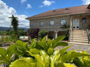 a house with green plants in front of it at Casa Ana Rosa in Arcos de Valdevez