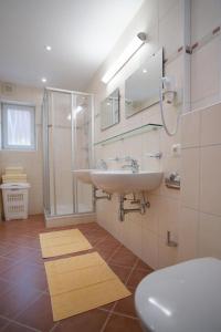 a bathroom with a sink and a shower and a toilet at Mountainpeak in Mayrhofen