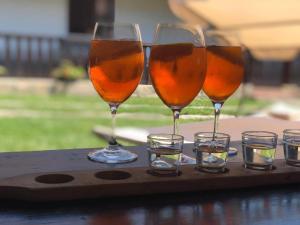 a tray with three wine glasses and some votives at Bodrogparti Vendégház Sárazsadány in Sárazsadány