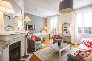 a living room with a fireplace and a table at Zen et Chic in Reims