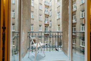 a chair on a balcony in front of a building at ShortStayPoland Klonowa (B29) in Warsaw