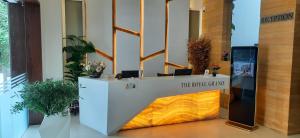 a reception desk with a sign on it in a lobby at The Royal Grand in Karūr