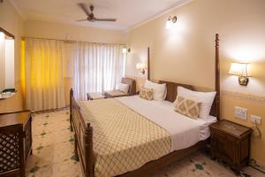 a bedroom with a large bed and a window at Hotel Jai Niwas in Jaipur