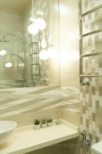a bathroom with a shower and a sink and a mirror at Luxury apartments «Love Story» in Ivano-Frankivsʼk