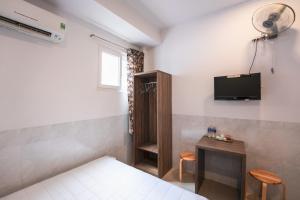 a bedroom with a bed and a tv on the wall at Thanh Ngọc Motel in Buon Ma Thuot