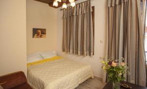 a small bedroom with a bed and a window at Argyro House I in Rethymno Town