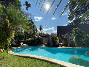 a swimming pool in the yard of a house at Little Eden Guesthouse in Pang Mapha