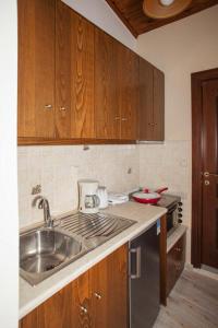 a kitchen with a sink and a counter top at Argyro House I in Rethymno Town +8 photos