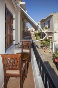 a balcony with two chairs and a table on a building at Argyro House I in Rethymno Town