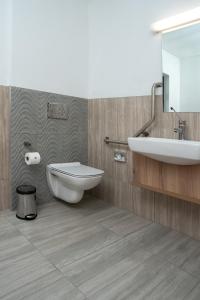 a bathroom with a toilet and a sink at LOCH LOGAN HOTEL in Bloemfontein