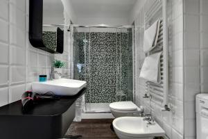 a bathroom with a sink and a toilet and a shower at Biennale superior suite in Venice