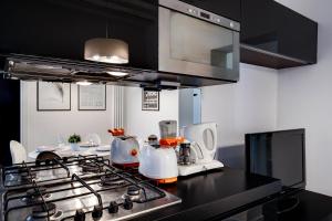 a kitchen with a black counter top with a stove at Biennale superior suite in Venice
