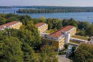 an aerial view of a building with a river at Seminaris SeeHotel Potsdam in Potsdam