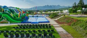 a water park with a pool and a water slide at Pensjonat pod Kotelnicą in Białka Tatrzanska
