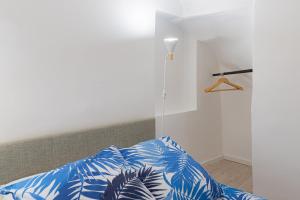 a bedroom with a bed with blue and white sheets at Vence...sur les pas de Matisse in Vence