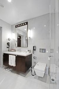 a bathroom with a sink and a toilet and a mirror at Crowne Plaza Bursa Convention Center & Thermal Spa, an IHG Hotel in Bursa