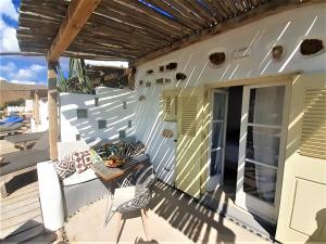 a balcony of a house with a table and chairs at Sea Side Studios & Houses in Kalo Livadi