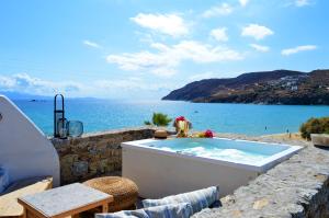 a bath tub with a view of the ocean at Sea Side Studios & Houses in Kalo Livadi